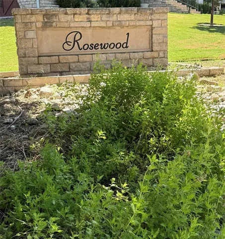 a view of a sign board with yard