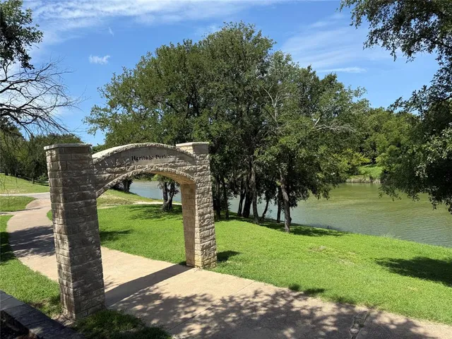 a view of a park with a tree in the background