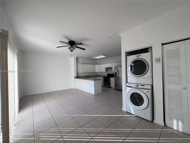 a view of a kitchen with a sink a washer and dryer