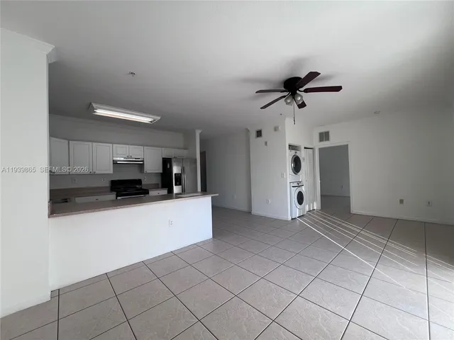 a kitchen with stainless steel appliances a refrigerator and a stove top oven