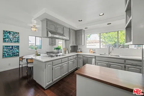 a kitchen with a sink and cabinets