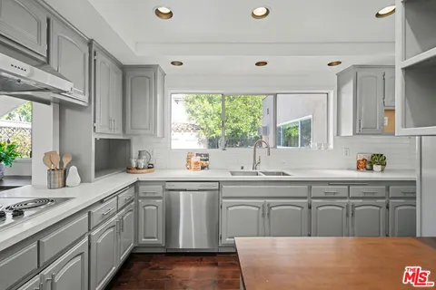 a kitchen with counter top space and stainless steel appliances