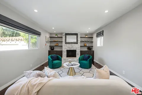 a kitchen with a sink window and cabinets