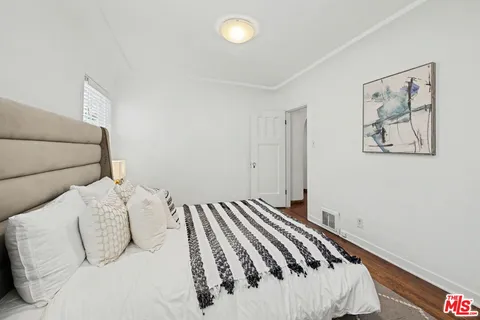 a bedroom with a large bed and a lamp