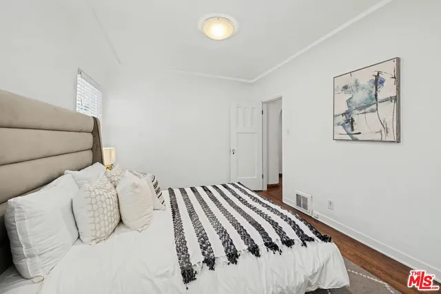 a bedroom with a large bed and a lamp