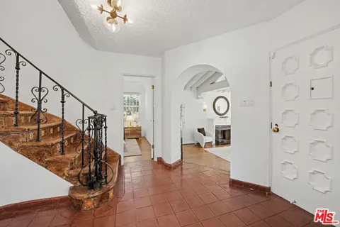 a bedroom with a bed and a lamp with window