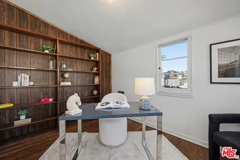 a bedroom with a bed and a chair