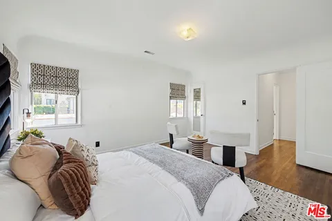 a living room with patio furniture and a potted plant