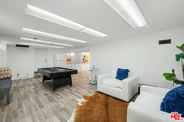 a building outdoor space with patio furniture and potted plants