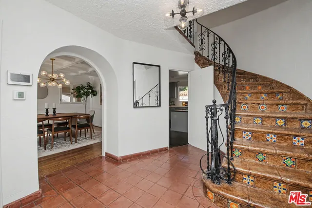 a living room with furniture a fireplace a rug and a window
