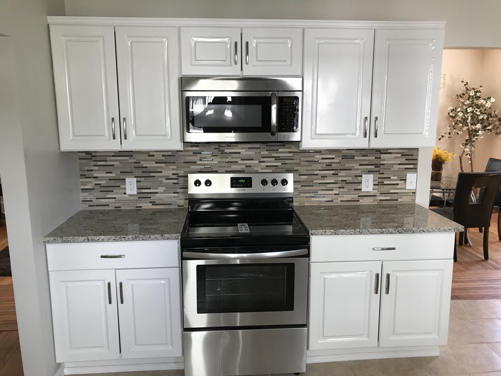 65 Grand Street Springfield, MA 01108 - Photo 1 of 30 a kitchen with granite countertop white cabinets and stainless steel appliances