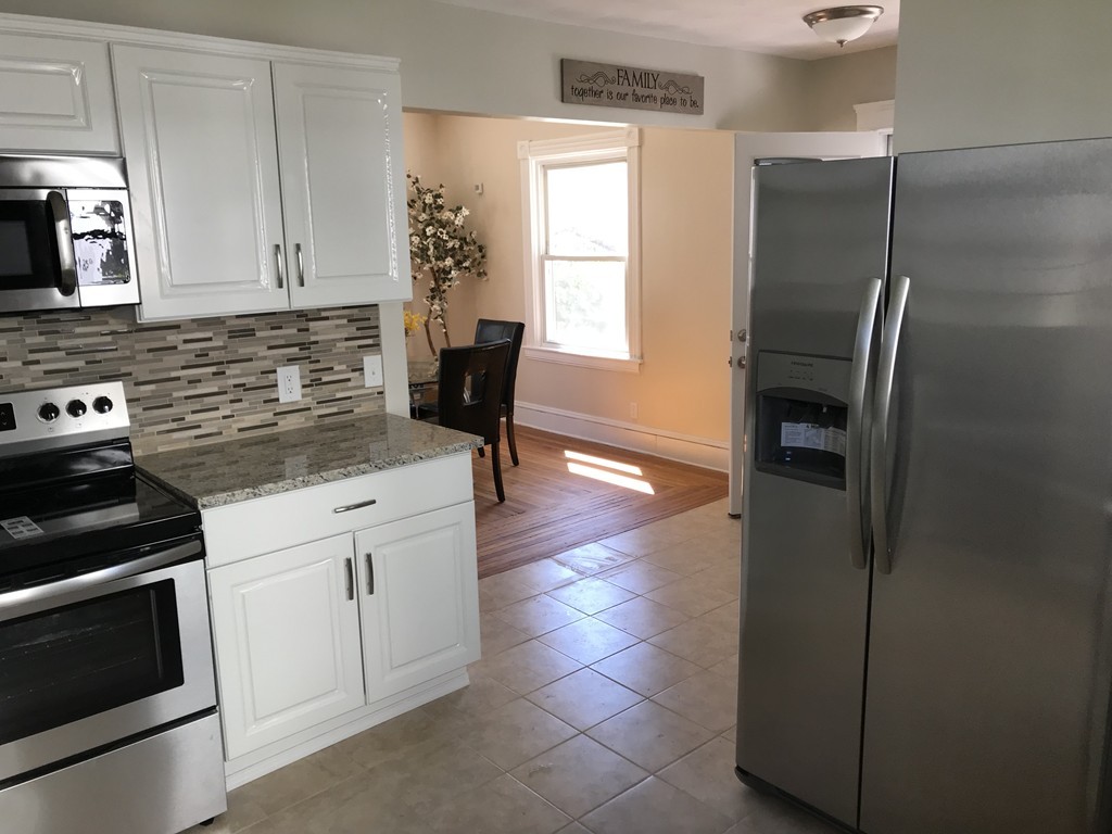65 Grand Street Springfield, MA 01108 - Photo 2 of 30 a kitchen with a refrigerator and cabinets
