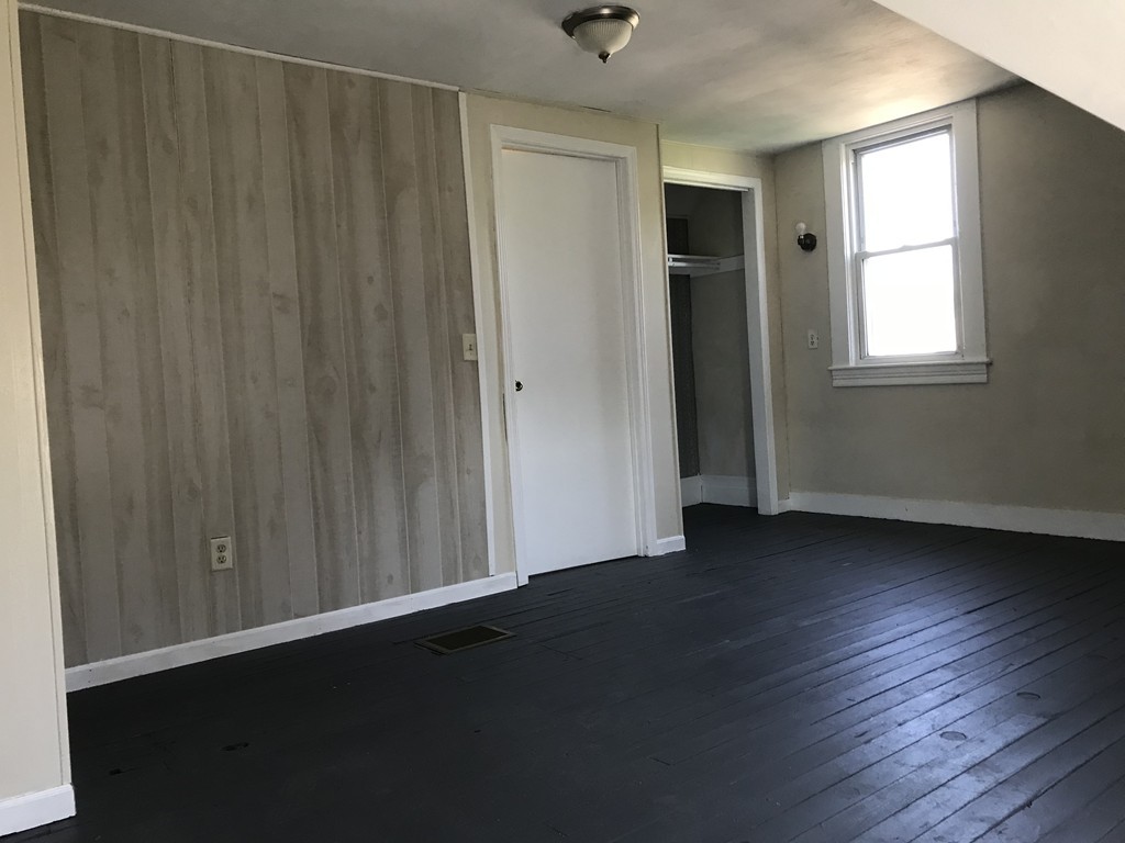 65 Grand Street Springfield, MA 01108 - Photo 28 of 30 an empty room with wooden floor and windows