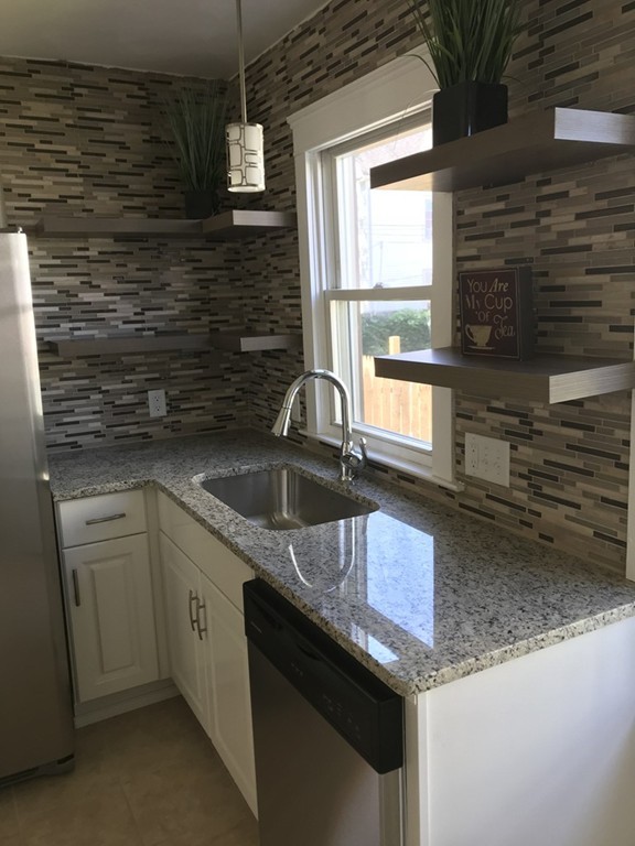 65 Grand Street Springfield, MA 01108 - Photo 3 of 30 a kitchen with stainless steel appliances granite countertop a sink stove and cabinets