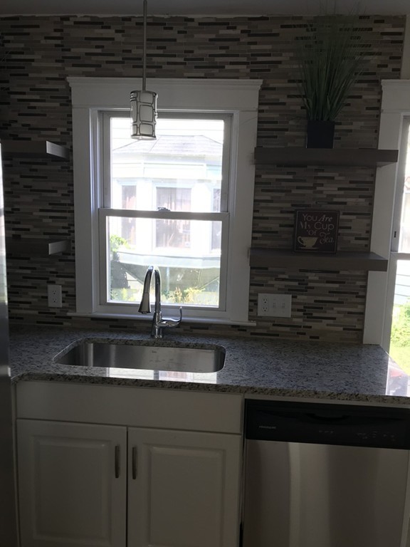 65 Grand Street Springfield, MA 01108 - Photo 4 of 30 a kitchen with granite countertop a sink and a window
