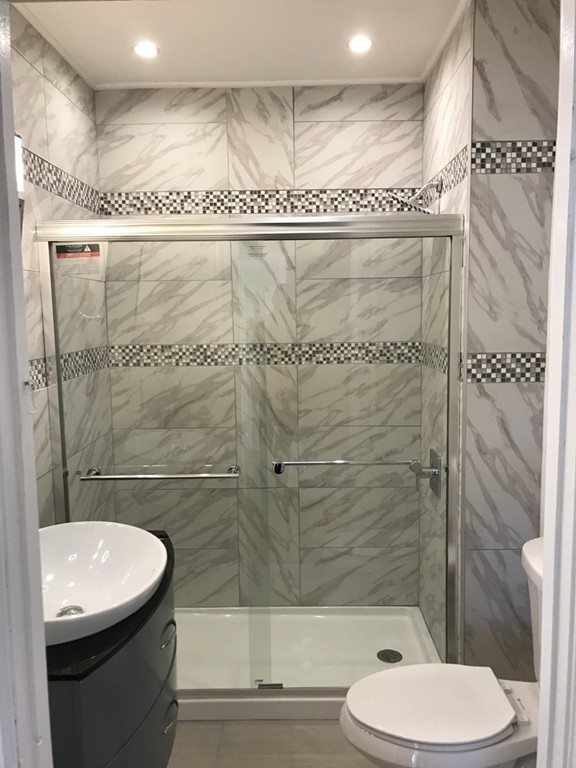 65 Grand Street Springfield, MA 01108 - Photo 7 of 30 a bathroom with a sink a toilet and shower