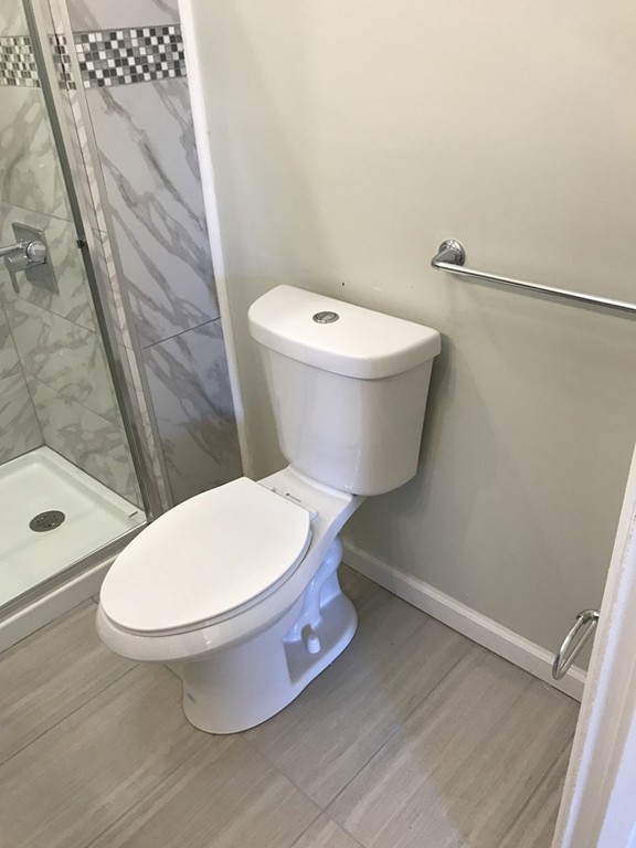 65 Grand Street Springfield, MA 01108 - Photo 8 of 30 a bathroom with a toilet and a shower