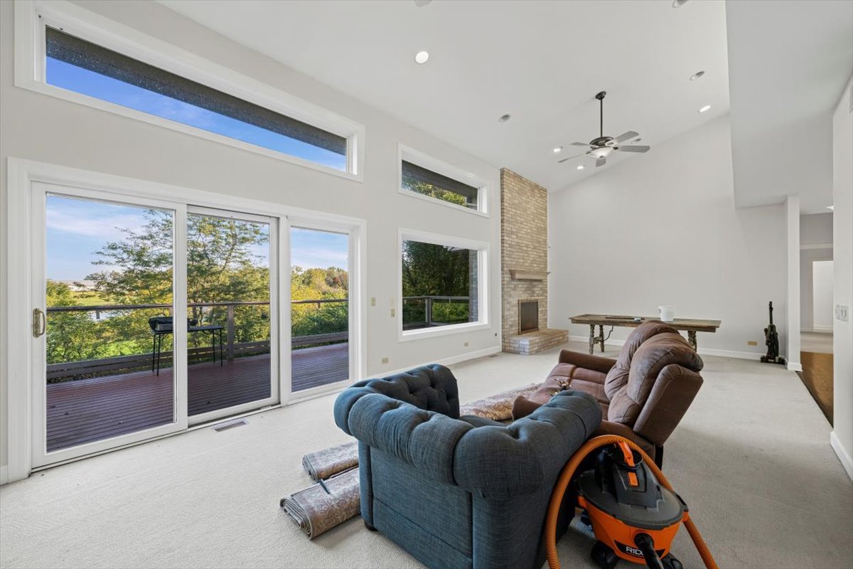 7510 East Tryon Grove Road Richmond, IL 60071 - Photo 14 of 63 a living room with furniture and a floor to ceiling window