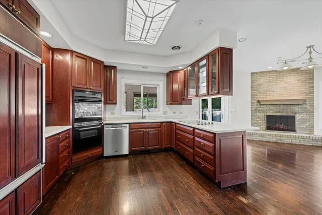 a kitchen with stainless steel appliances kitchen island wooden cabinets and granite counter tops
