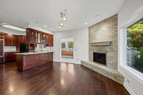 a large bed sitting in a room next to a window