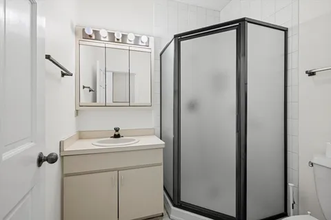 a hallway with a sink and a toilet