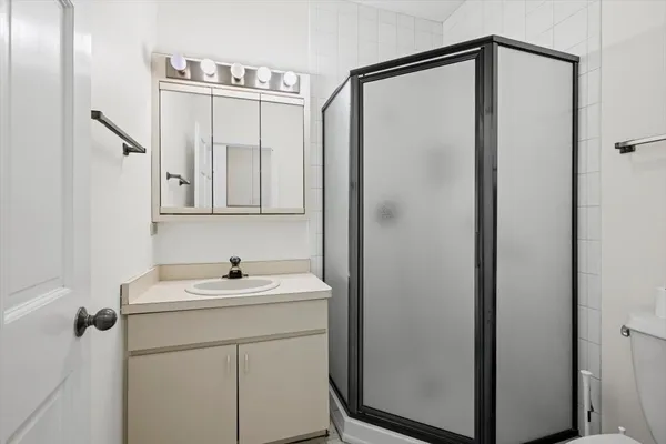 a hallway with a sink and a toilet