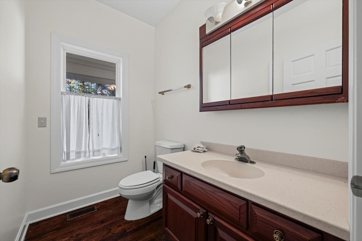 7510 East Tryon Grove Road Richmond, IL 60071 - Photo 25 of 63 a bathroom with a sink a toilet and mirror
