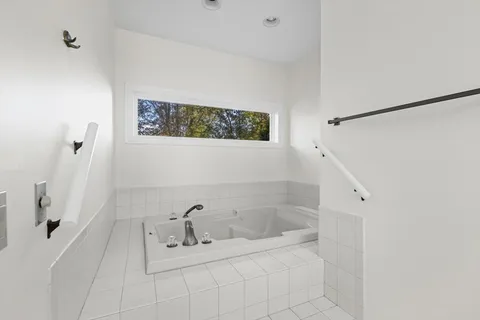 an empty room with a ceiling fan and a window