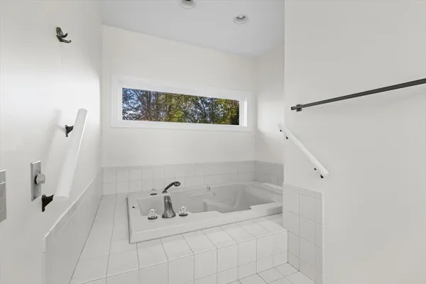 an empty room with a ceiling fan and a window