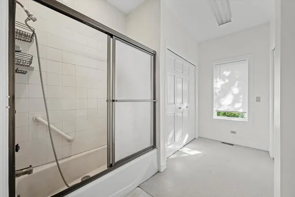 a bathroom with a shower and a sink