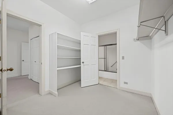 a view of a room with gym equipment and a view of a storage