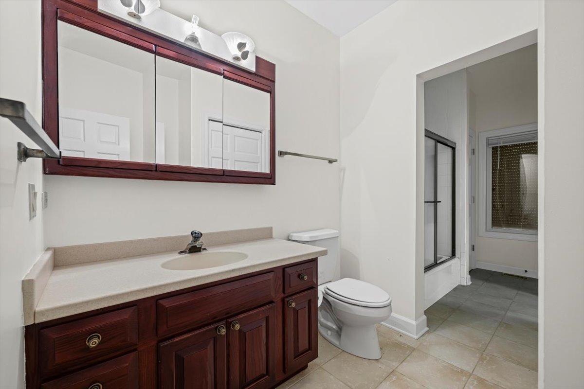7510 East Tryon Grove Road Richmond, IL 60071 - Photo 38 of 63 a bathroom with a toilet a sink and mirror
