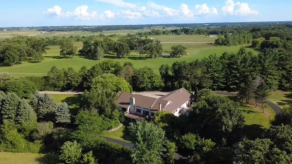 an aerial view of a house with a yard