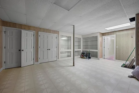 an aerial view of residential house with outdoor space and trees all around