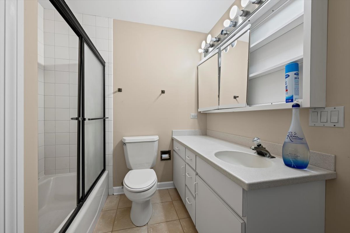 7510 East Tryon Grove Road Richmond, IL 60071 - Photo 49 of 63 a bathroom with a sink a toilet and shower