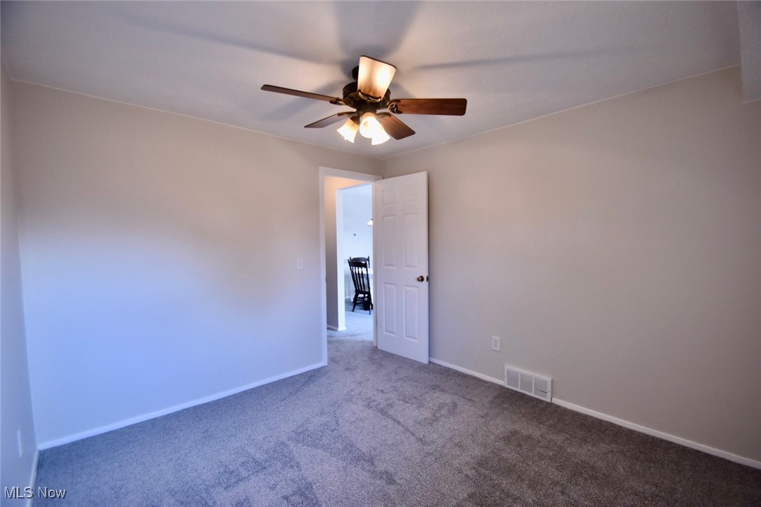 8955 West Ridge Road, Unit D Elyria, OH 44035 - Photo 27 of 33 Spare room featuring ceiling fan and carpet floors