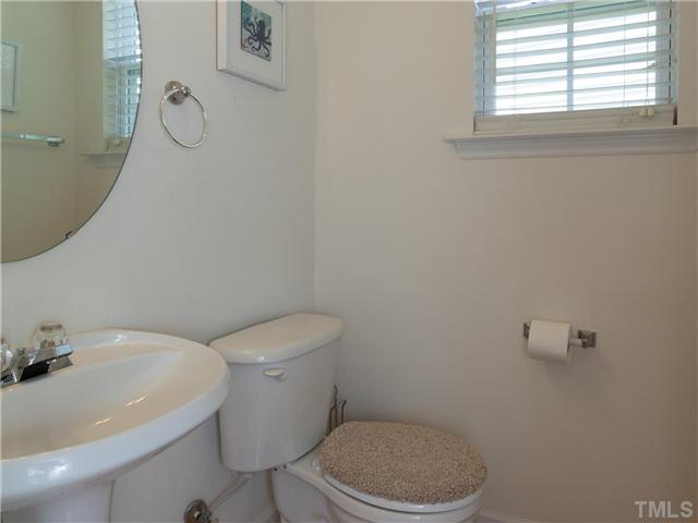8433 Aztec Dawn Court Raleigh, NC 27613 - Photo 12 of 23 convenient powder room with window and pedestal sink on the first floor!