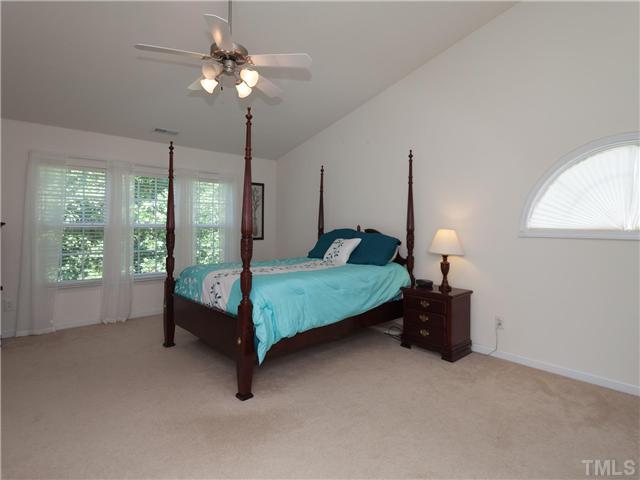 8433 Aztec Dawn Court Raleigh, NC 27613 - Photo 13 of 23 The Master bedroom is Enormous with double door entry, 3 windows and palladium window, vaulted ceiling, ceiling fan, HUGE WIC and linen closet,