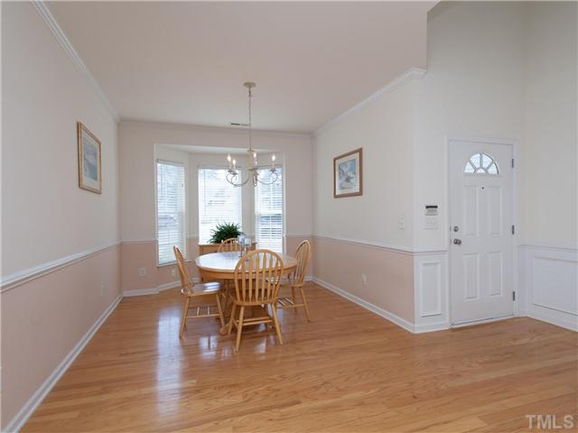 8433 Aztec Dawn Court Raleigh, NC 27613 - Photo 3 of 23 Hardwood floors and crown molding on the entire first floor! Beautiful Stairway with open end treads and wainscoting in the foyer and chair rail in the dining room!