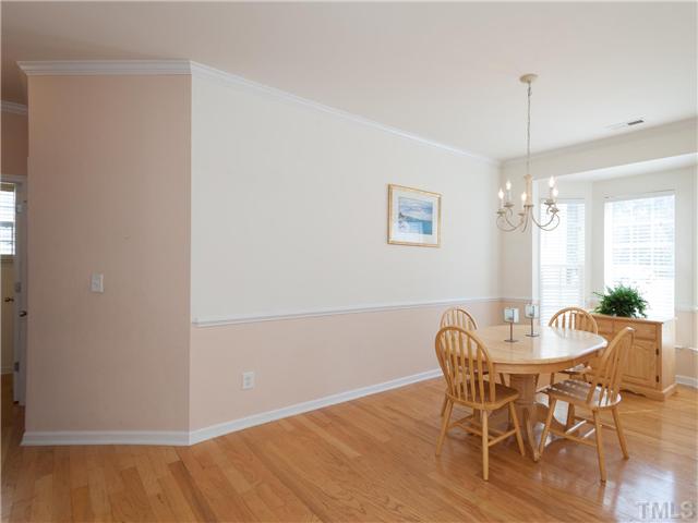 8433 Aztec Dawn Court Raleigh, NC 27613 - Photo 4 of 23 The Formal Dining Room is off the Foyer and connects to the Kitchen through a nearby hallway! The bay window, hardwoods and chair rail make this formal dining room extra nice for big gatherings!