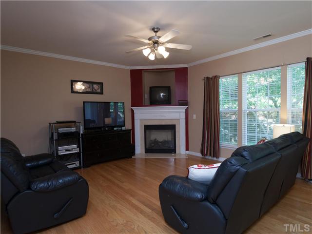 8433 Aztec Dawn Court Raleigh, NC 27613 - Photo 23 of 23 In the back of the home, there is a HUGE Living Room with 3 windows, upgraded ceiling fan and gas log fireplace! You will love this open floor plan, with Living room open to the breakfast room and Kitchen- Great for entertaining!
