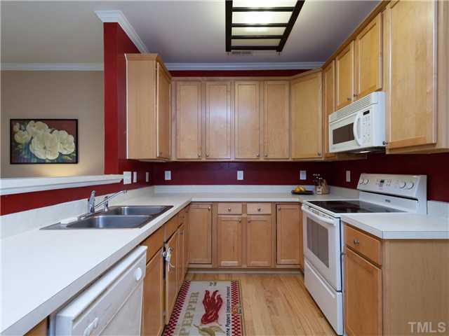 8433 Aztec Dawn Court Raleigh, NC 27613 - Photo 8 of 23 The Kitchen has 42 inch maple cabinets, breakfast bar, pantry storage and sunny breakfast room -Perfect for casual meals! Kitchen features smooth top range, built-in microwave and Refrigerator ALL INCLUDED!