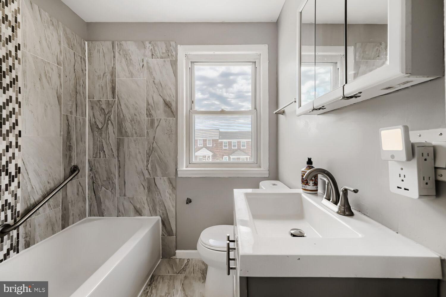 1014 Lyndhurst Street Baltimore, MD 21229 - Photo 22 of 29 a bathroom with a sink and a bathtub