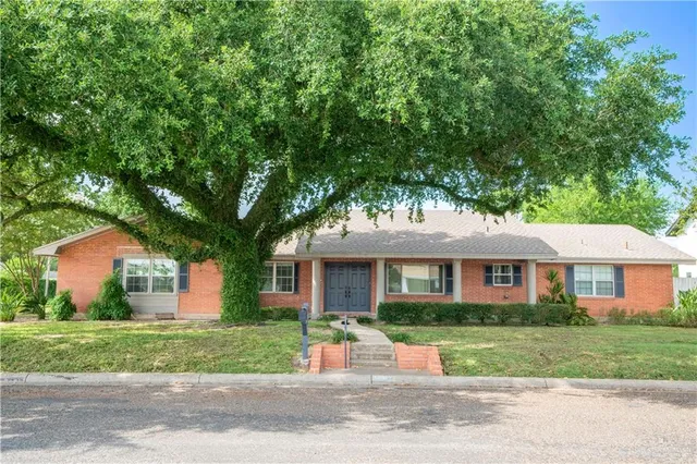 front view of a house next to a yard