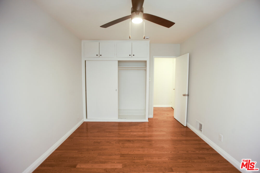 1323 South Ridgeley Drive, Unit 2 Los Angeles, CA 90019 - Photo 9 of 11 a view of empty room with wooden floor