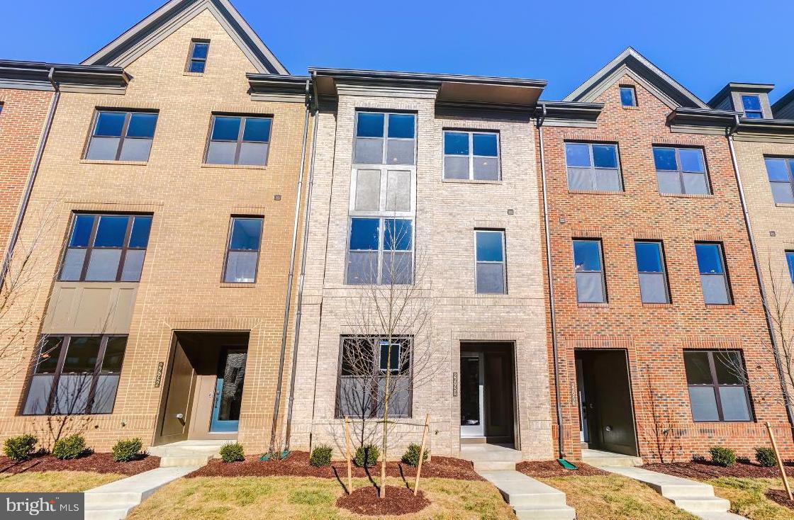 22954 Sullivans Cove Square Brambleton, VA 20148 - Photo 1 of 38 a view of a brick house with many windows