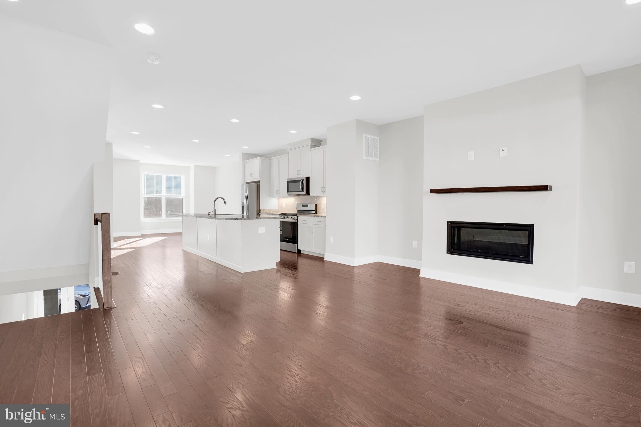 22954 Sullivans Cove Square Brambleton, VA 20148 - Photo 12 of 38 a view of a living room a fireplace with wooden floor