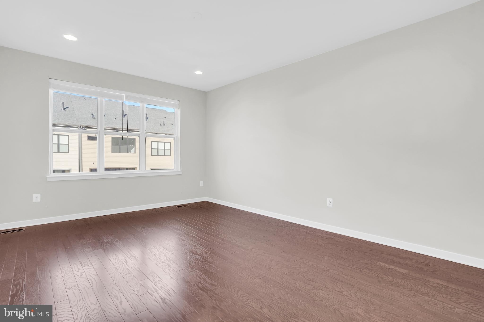 22954 Sullivans Cove Square Brambleton, VA 20148 - Photo 18 of 38 a view of an empty room with wooden floor and a window