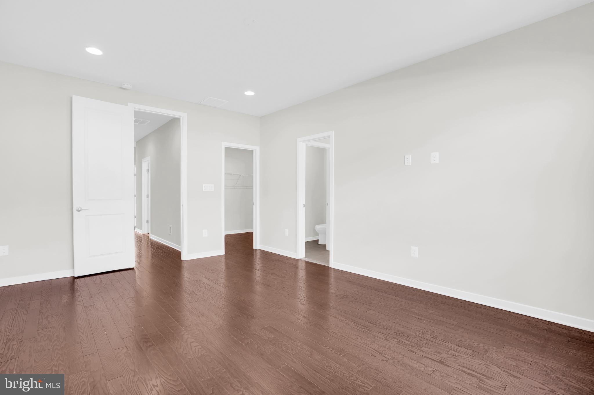 22954 Sullivans Cove Square Brambleton, VA 20148 - Photo 20 of 38 a view of an empty room with wooden floor and closet