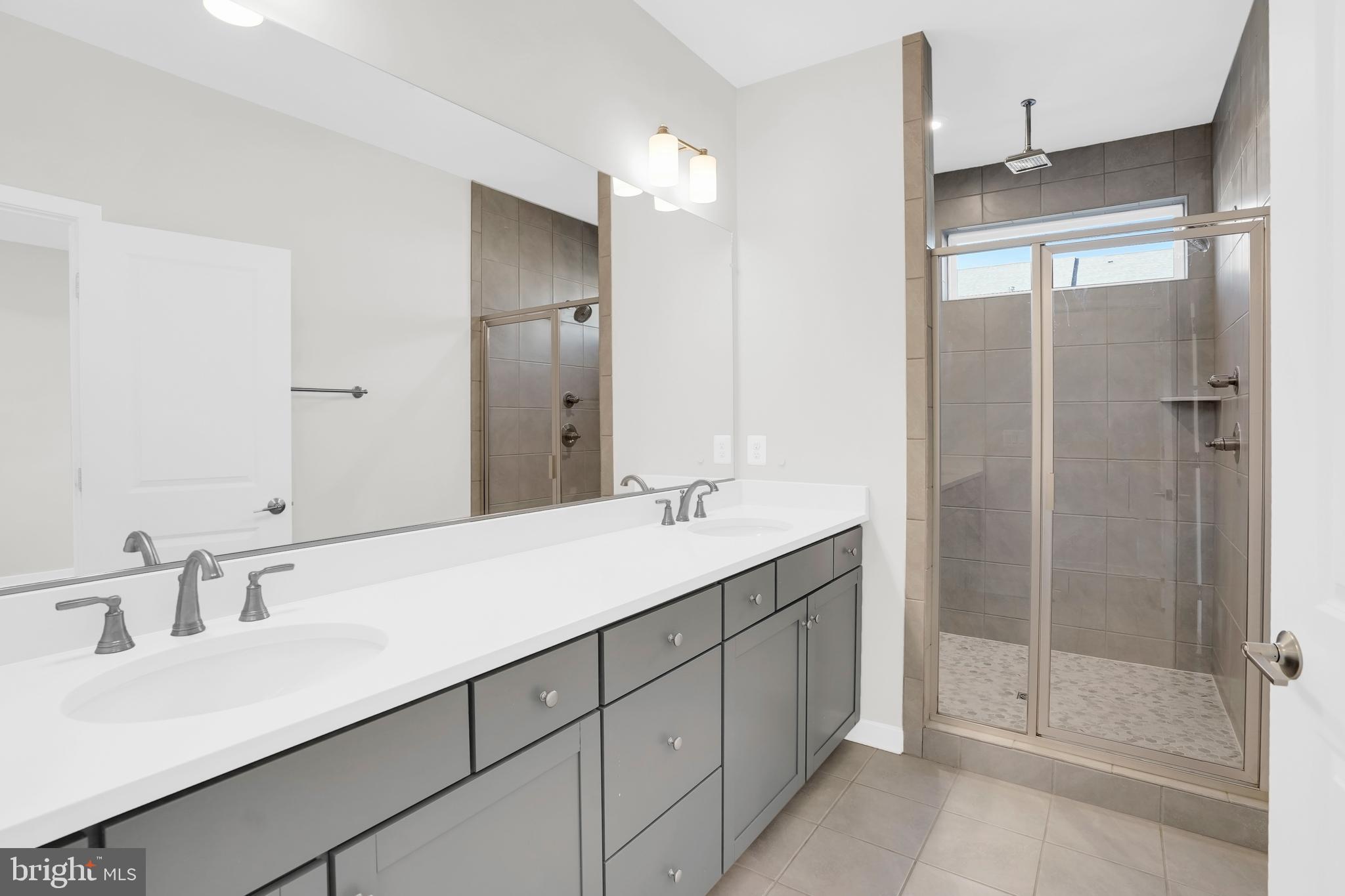 22954 Sullivans Cove Square Brambleton, VA 20148 - Photo 21 of 38 a bathroom with a double vanity sink mirror and shower